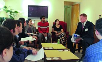Robert Douglas ’70 and Cristen Kromm (on red chair), assistant dean for community development and residential programs, meet with students as part of the Living and Learning Center programming.